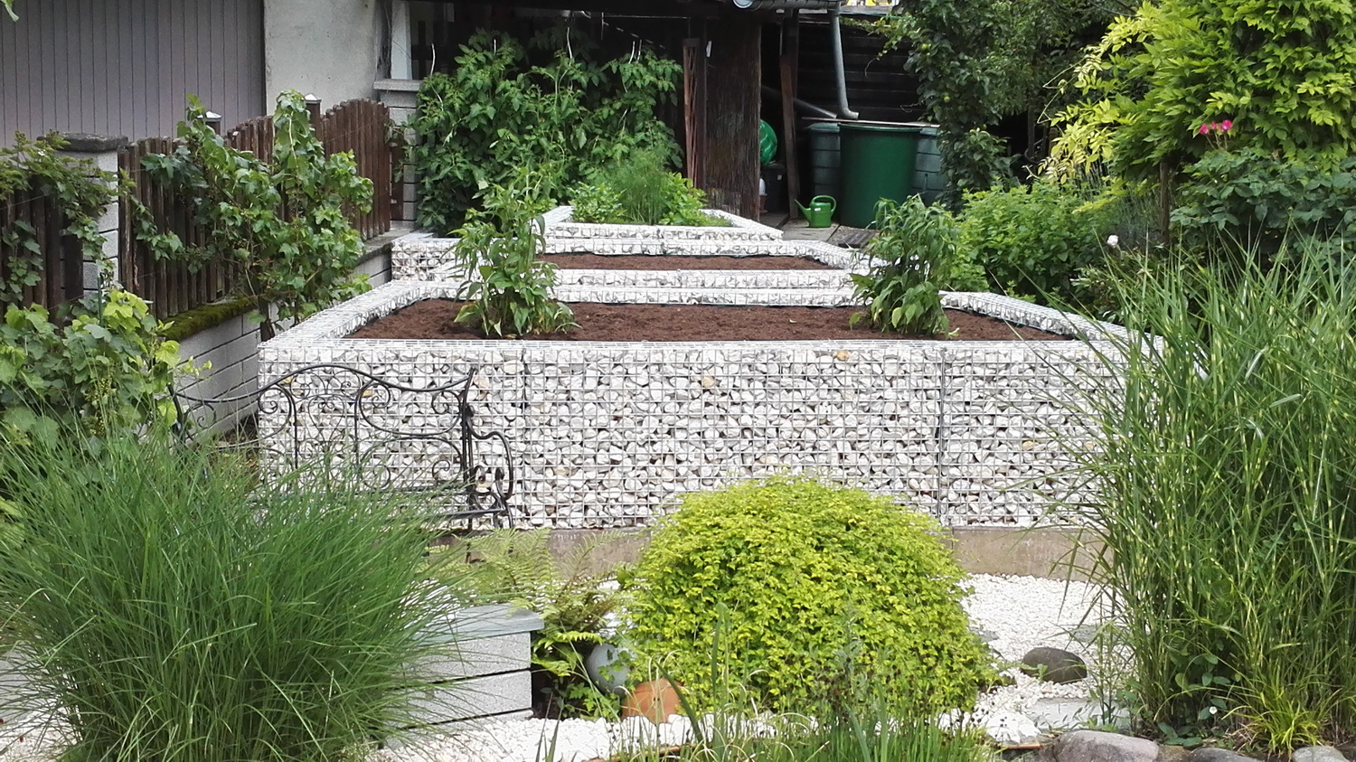 Bloembak van schanskorven in de tuin